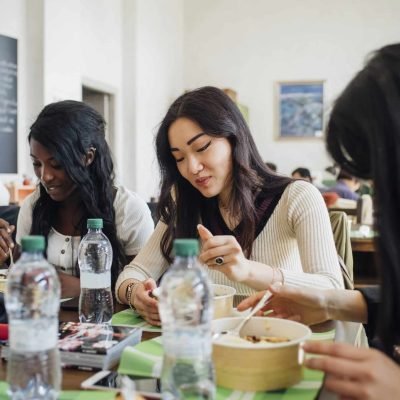 Young male and female business team sharing lunch in cafe